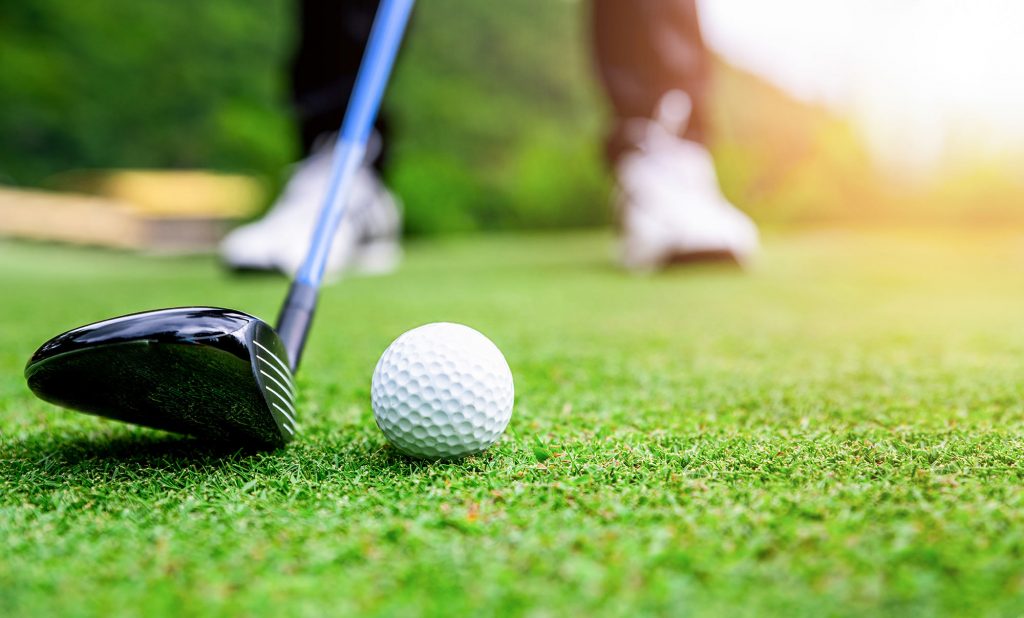 Golf Ball and Club ready to tee off