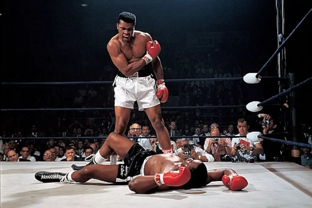 One of the greatest athletes of all time Muhammad Ali standing above his opponent