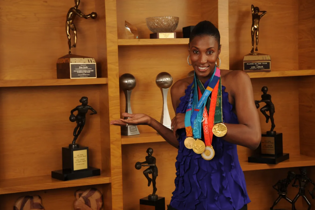 WNBA legend Lisa Leslie with her collection of trophies and medals