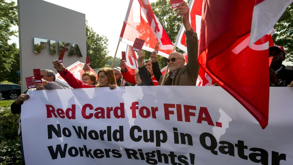 Protests for 2022 World Cup in Qatar with banner saying "Red Card for FIFA".