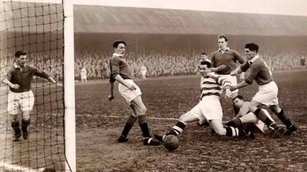 One of the world's most popular sports - An old photo of football being played in front of a crowd