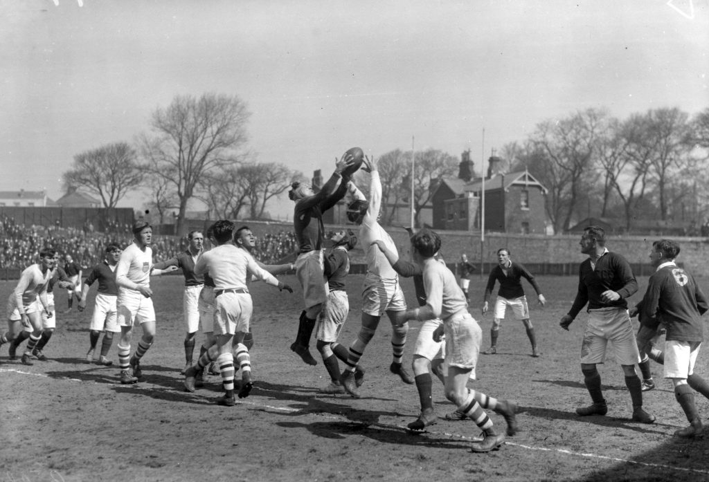 An old photo of a lineout in a rugby game, one of the most popular sports that originates from the UK