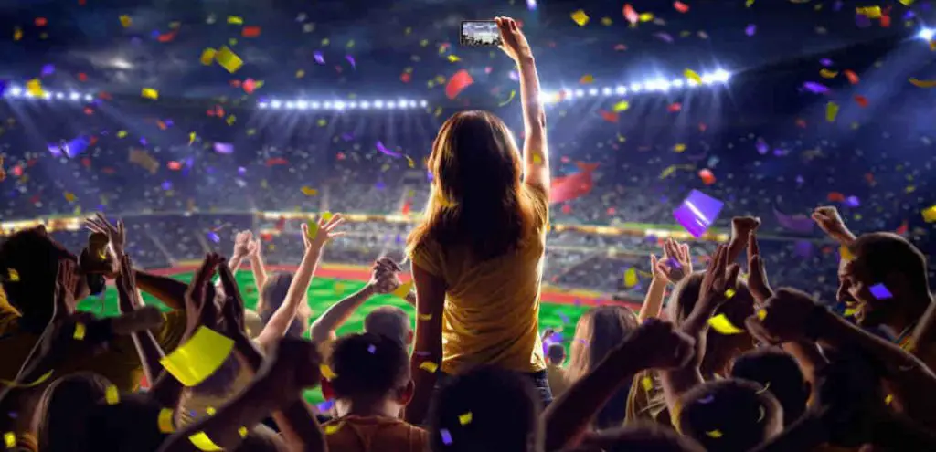 Sports fans in a stadium contacting That's All Sport on a mobile