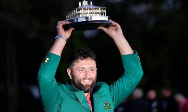 Jon Rahm wears the green jacket