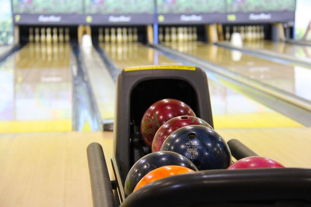 Bowling Balls in a Rack and the alley in the distance