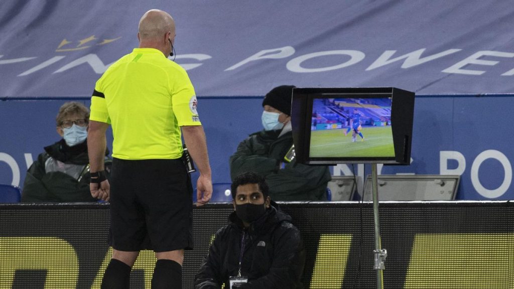 VAR with referee reviewing a decision on a Pitch Side Monitor