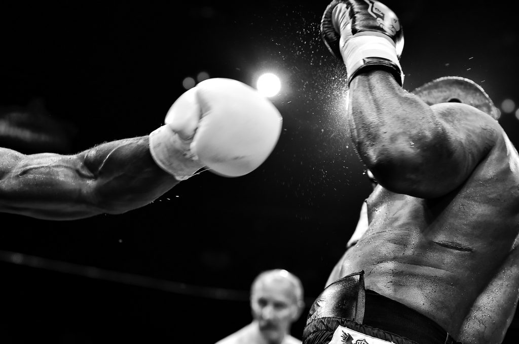 Image from a Boxing match showing the strength behind a punch hitting another boxer