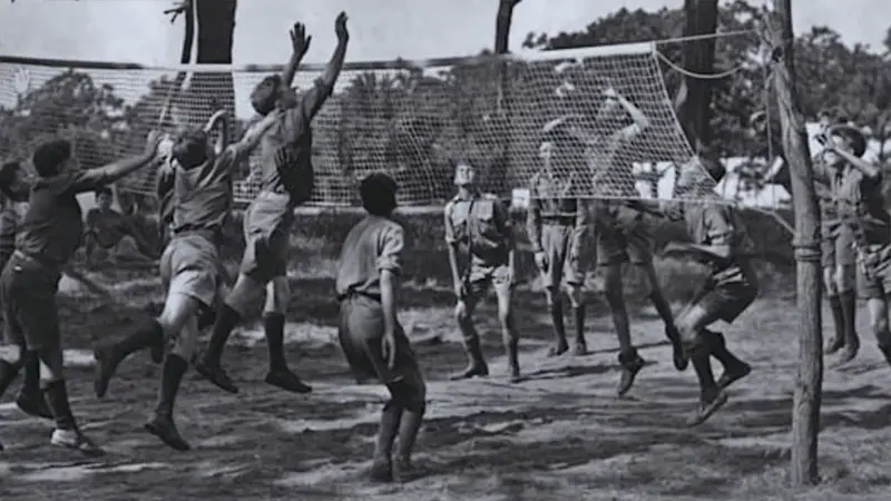 A black and white picture of Volleyball being played