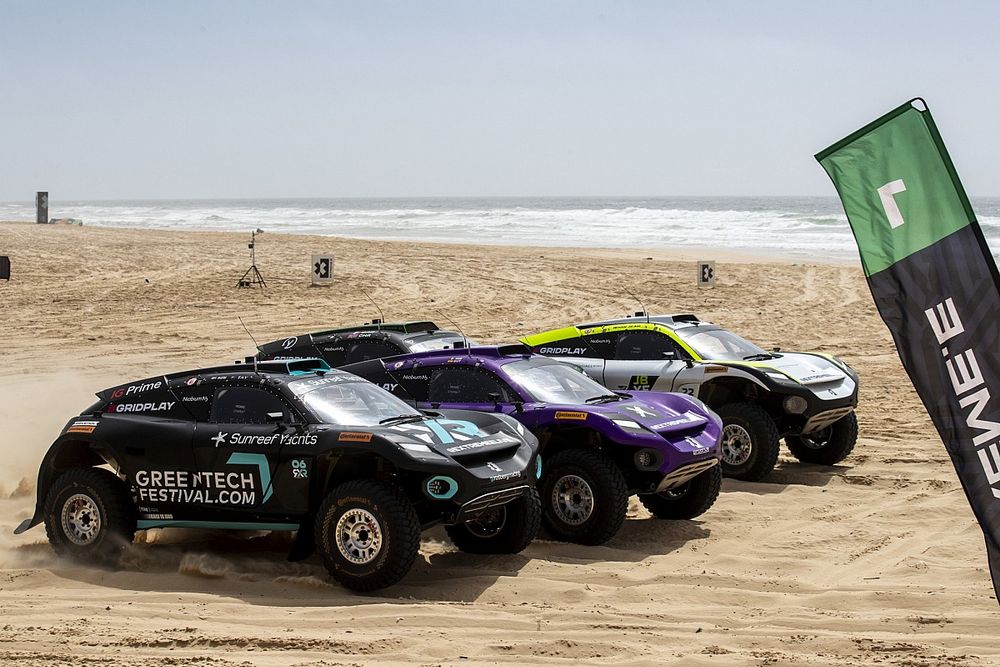 4x4 vehicles on a beach taking part in the Eco Racing Series