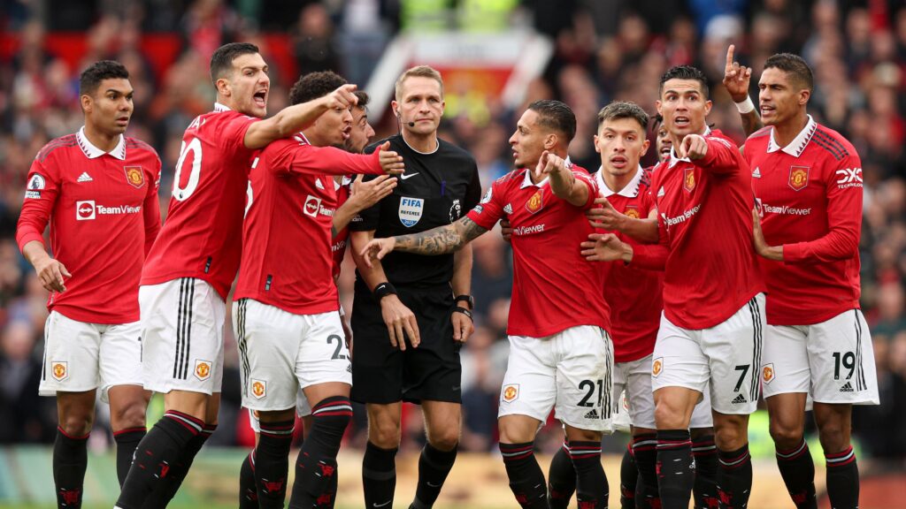 United Players surrounding the Referee in the Premier League trying to influence his decision