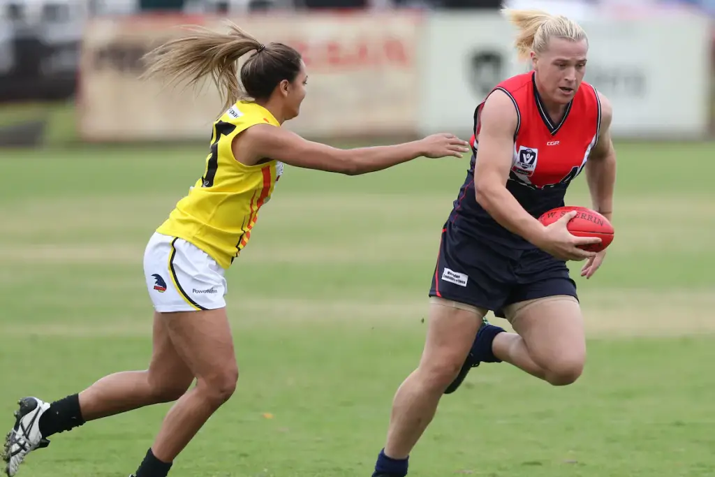 Two women playing Aussie Rules