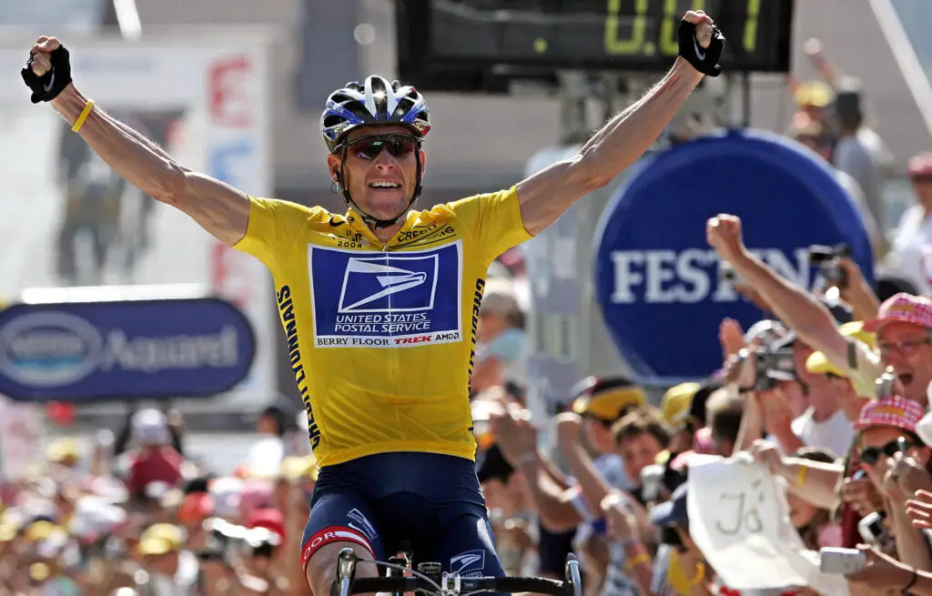 Lance Armstrong celebrating a Tour de France win after battling back from Testicular Cancer before doping allegations