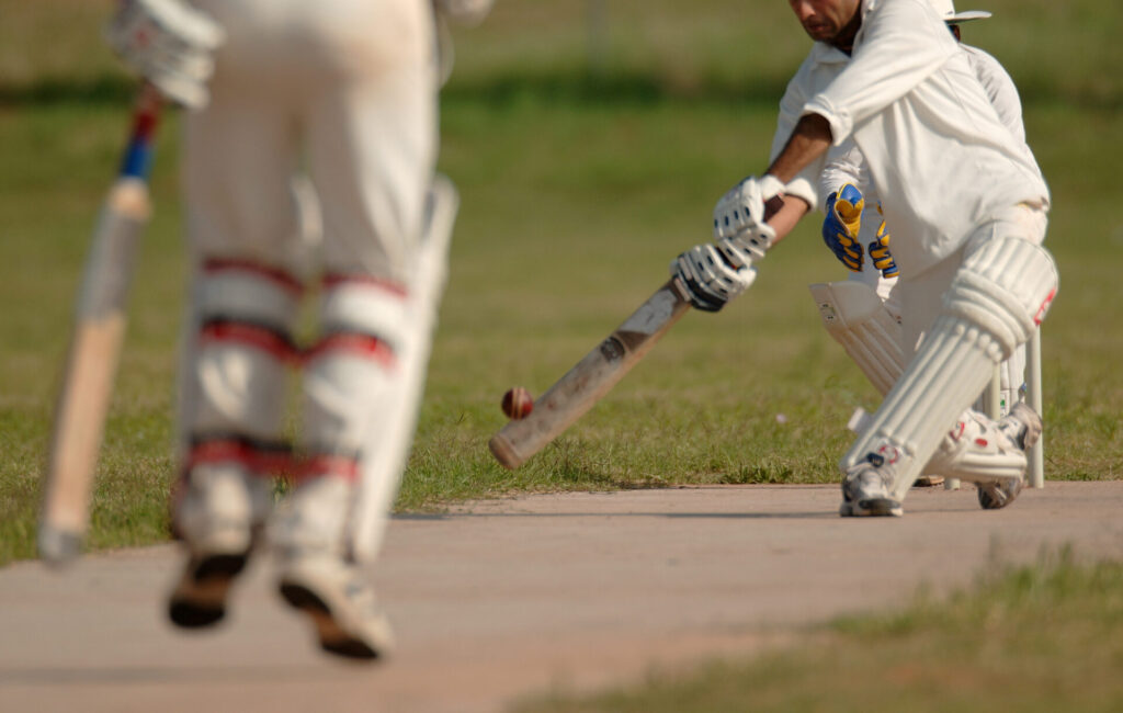 Player smashing the ball with their cricket bat