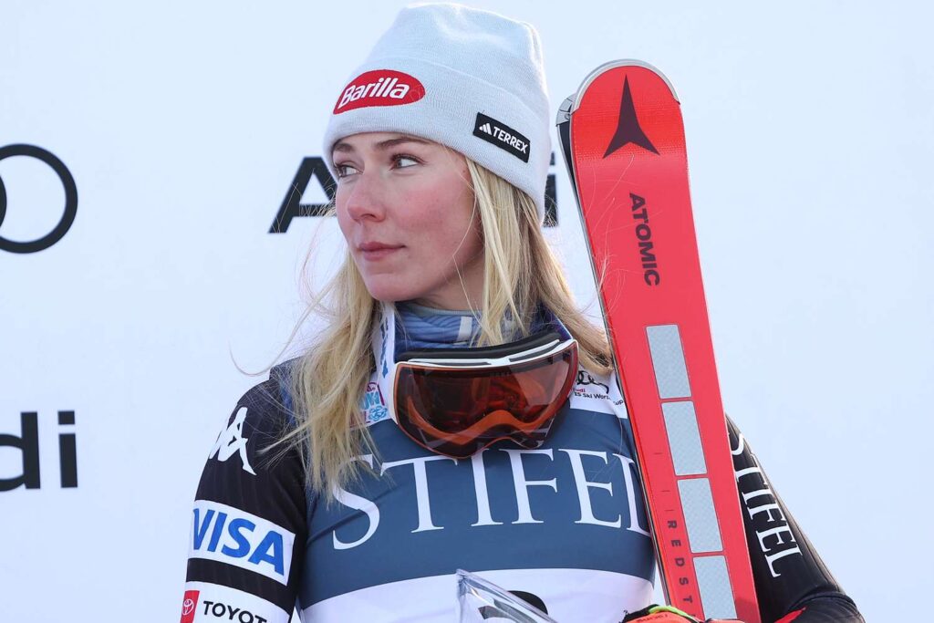 Mikaela Shiffrin standing with skis at a ski event